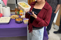 Smiling woman holding a tupperware  of delicious homemade food.