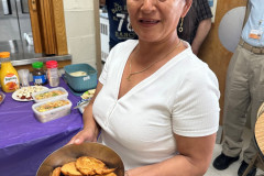 Smiling woman holding a bowl of delicious homemade food.