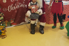 Student from the Catholic Charities Charles F. Murphy Early Childhood Development Center takes a photo with Santa during  a family engagement activity at the school.